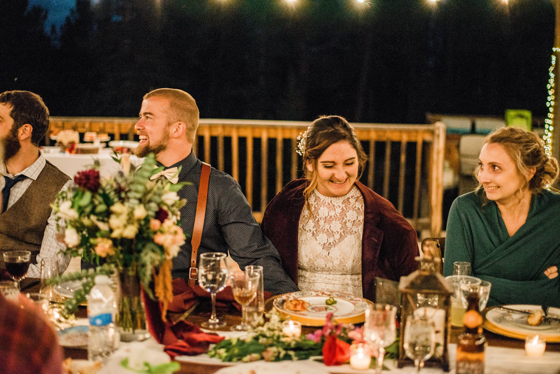 bride and groom laughing elopement dinner