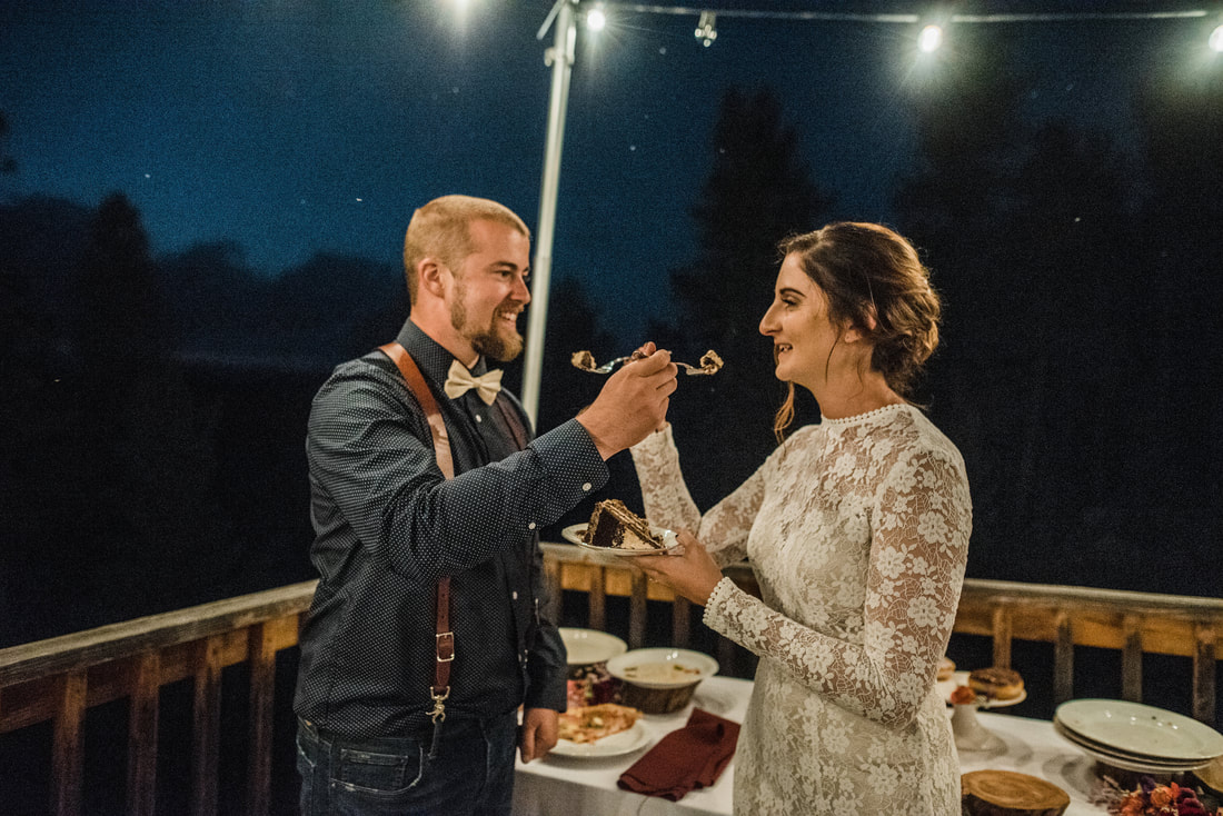 bride and groom feeding wedding cake