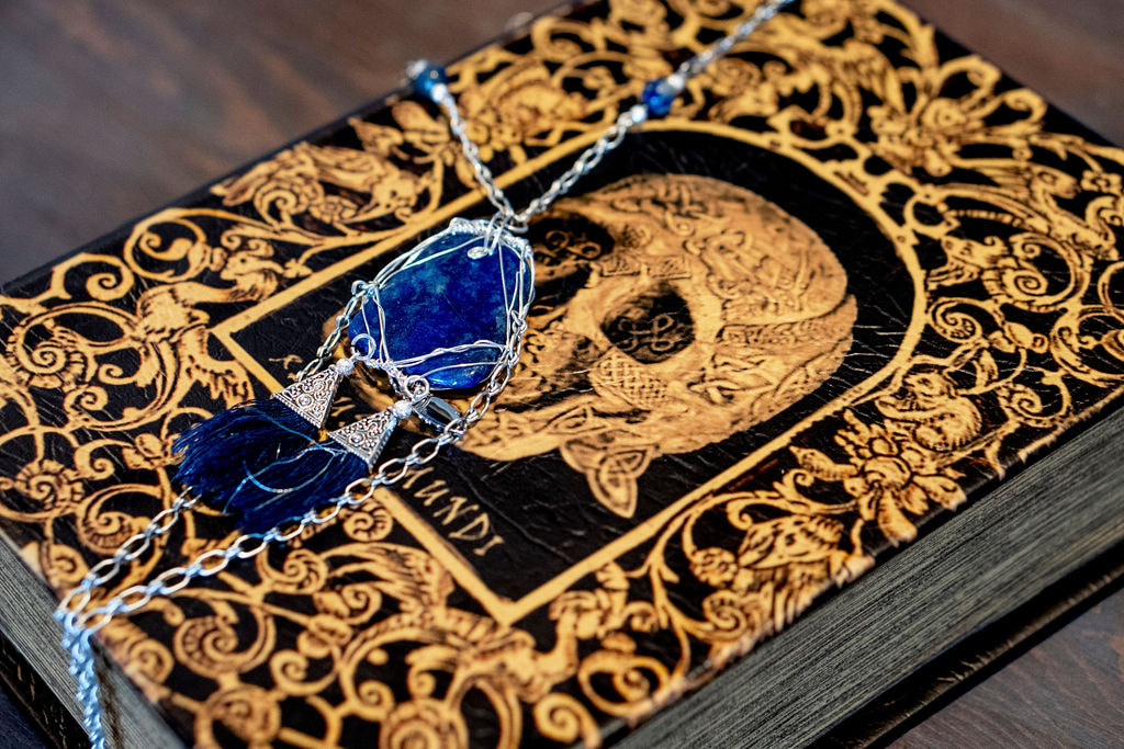 vow book and blue stone necklace