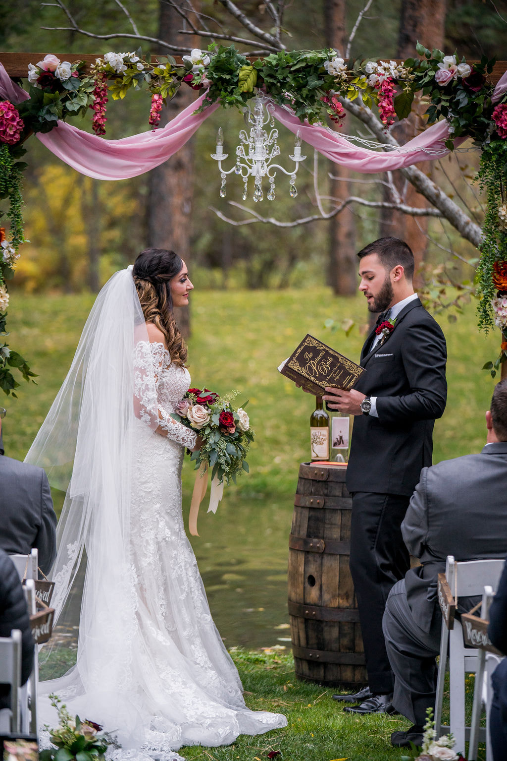 bride and groom read vows to each other from the princess bride book during romantic colorado wedding ceremony at dunafon castle