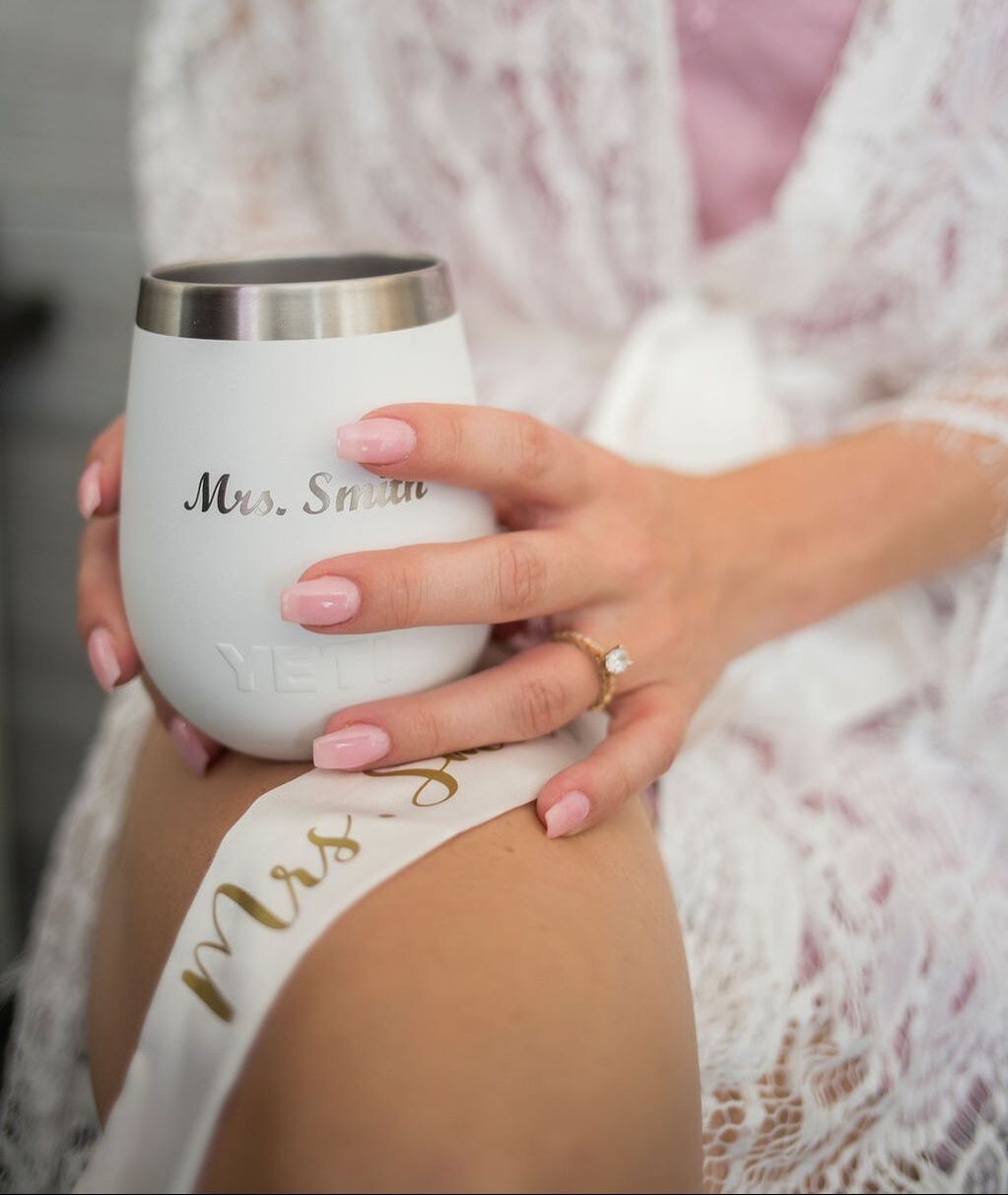 bride getting dressed with personalized yeti tumbler
