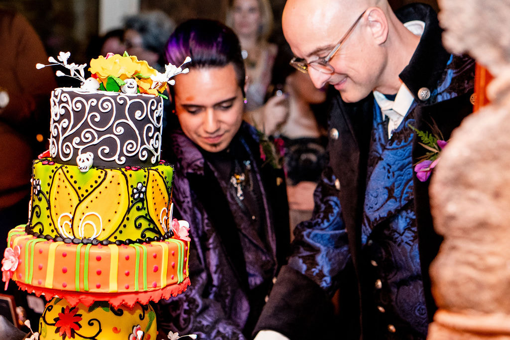 gay wedding couple cutting cake